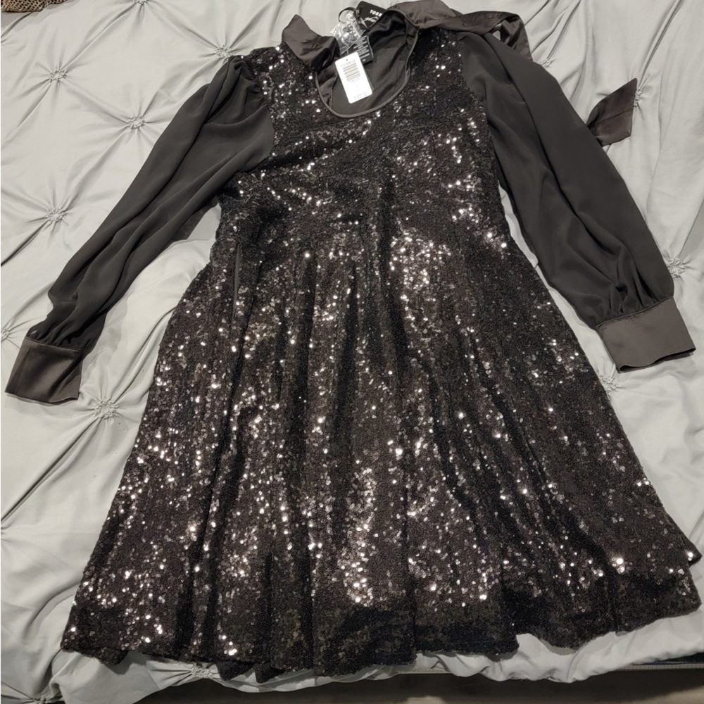New with tags. Torrid. Very fun and cute black dress with sequins.